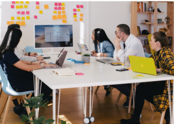 a team in an office researching cti during meeting