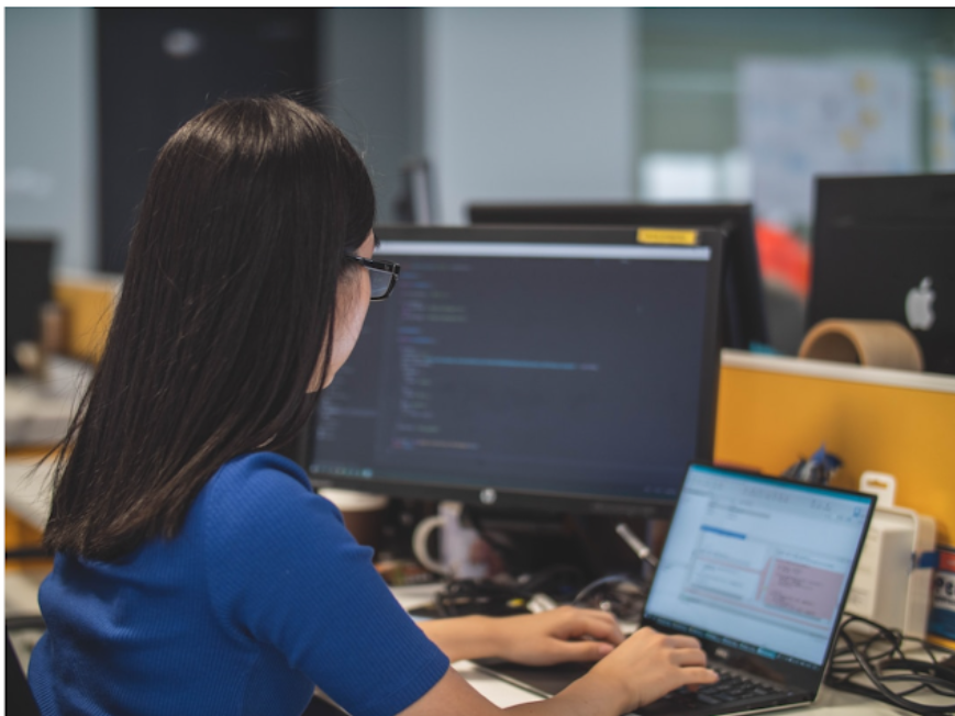 a woman in an office researching cti on her computer