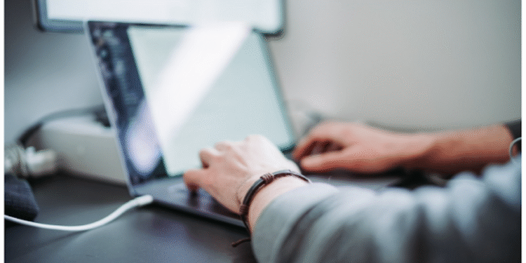 business employee using laptop for resource forecasting